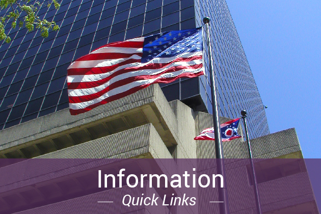 American and Ohio state flags on flag poles in front of a high rise building